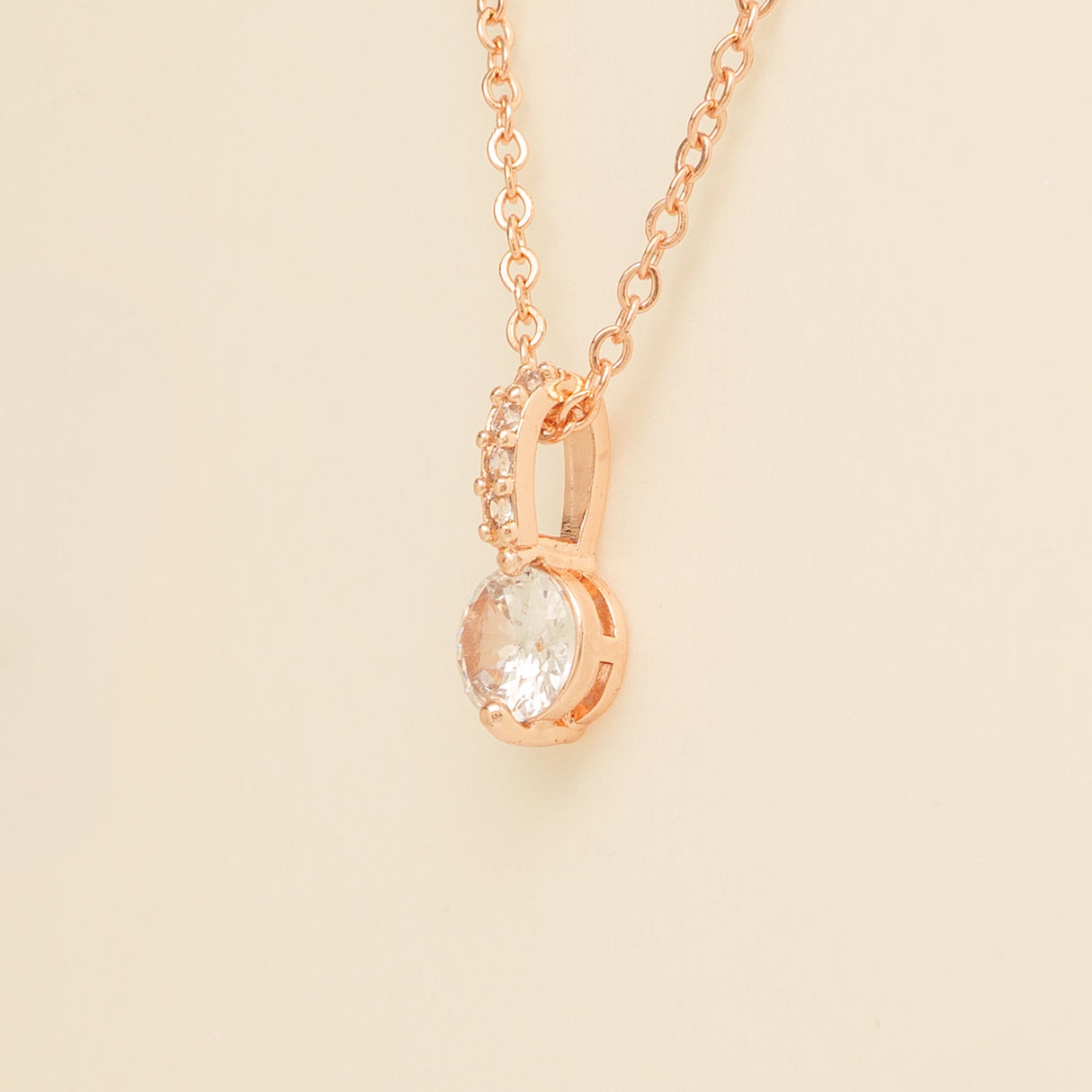 Close up of the Elegant Wishes rose gold crystal pendant and fine chain