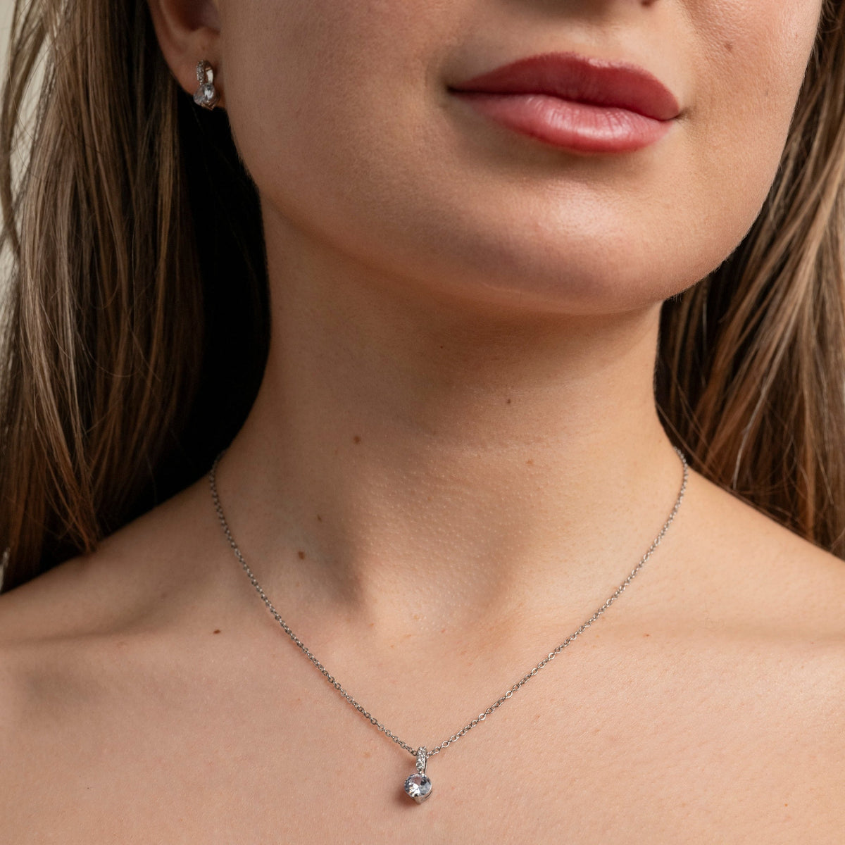 Close up of the Elegant Wishes silver crystal necklace on the neckline