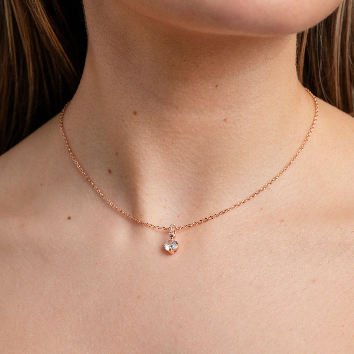 Bride wearing the Elegant Wishes rose gold crystal necklace